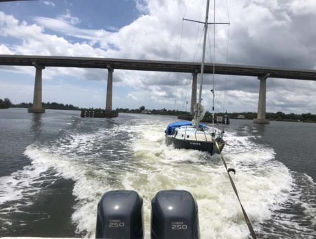Derelict sailboat abandoned in lagoon towed off by local resident, taken to landfill