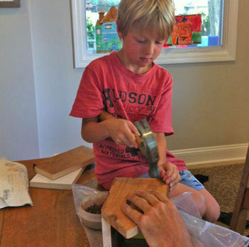 Young volunteer builds a “house” for Habitat