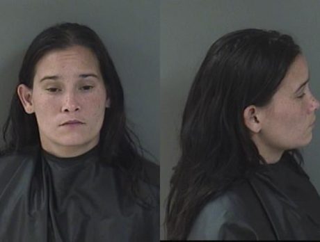 Man stabbed in back after argument; woman charged