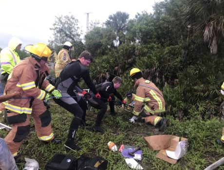 Bystanders help save man trapped in vehicle, officials say