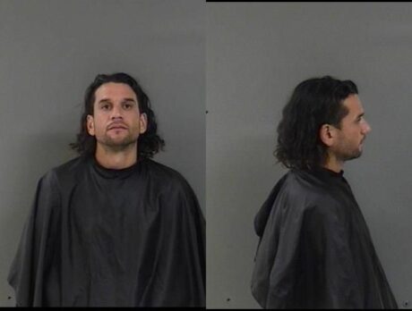 Man clings onto truck with kids inside to stop carjacker; suspect arrested