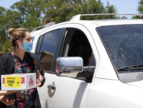 Helping others: Healthcare workers give food to needy