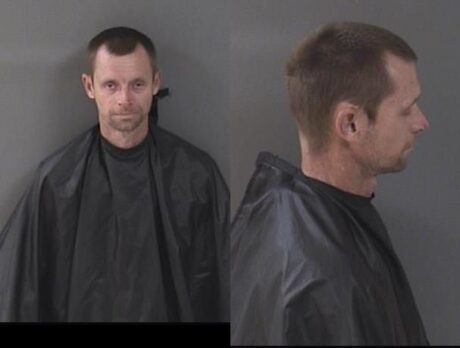 Man charged after being found unconscious with child in car