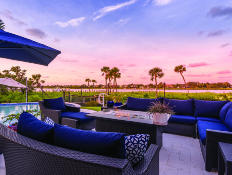 Elegant riverfront estate on large lot features pool, dock